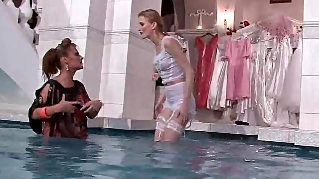 Blonde lesbian duo having fun wet in the pool
