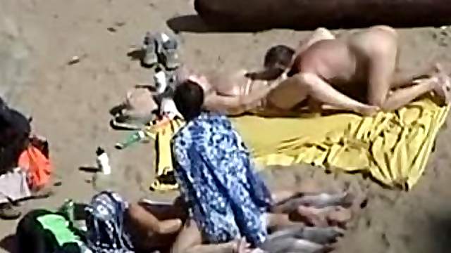 Girl gets her pussy fingered by her husband on a nude beach