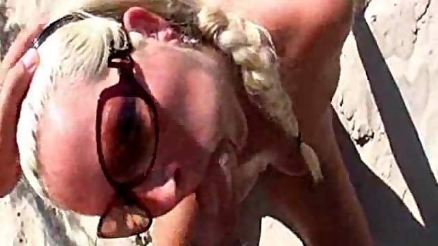 German blonde sucks a dick on a beach and enjoys doggy style sex