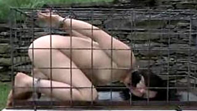Outdoor BDSM for Enema locked in a tiny cage