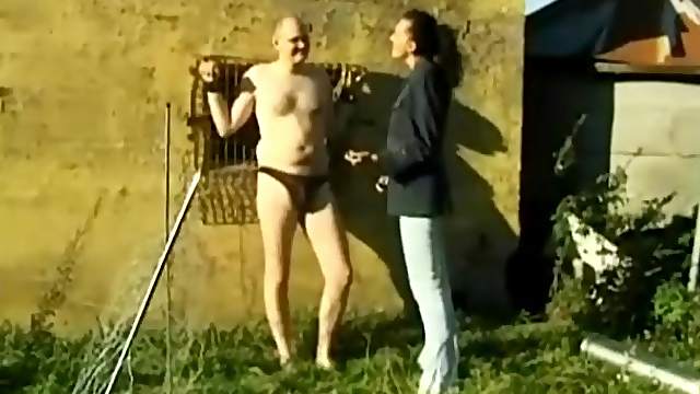 Tied up guy in glasses gets a handjob outdoors