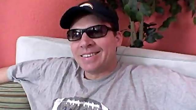 A gay daddy wearing glasses and a cap jerks his boner off