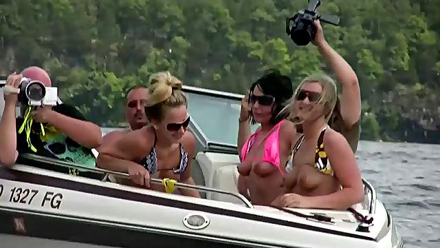 Nasty amateur girls sitting in a boat flash their boobs
