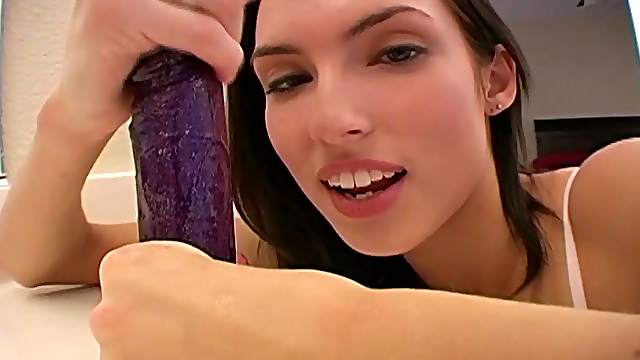 Endearing brunette solo model plays with a dildo in the bathroom