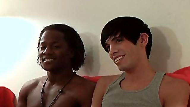 Ebony-skinned gay guy with a slim body sucking a big white cock