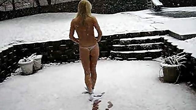 A cute blonde goes out in the snow wearing just her panties