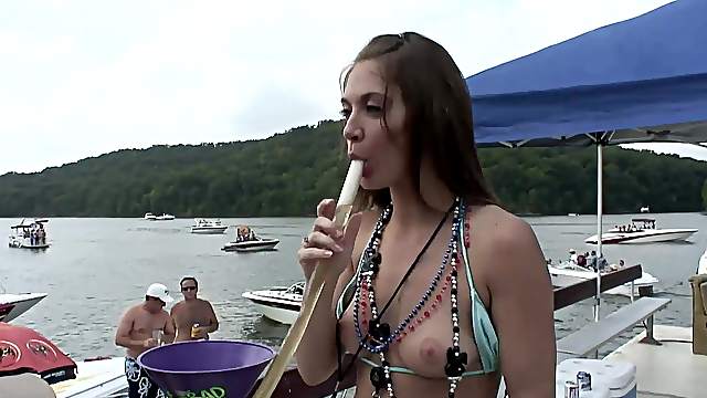 Showing her tits on the boat makes this cute brunette happy