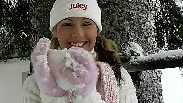 An adventurous hottie rubs snow against her shaved pussy