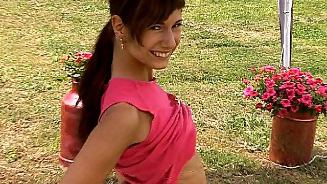 This cute, smiling teen babe loves to cum in the backyard