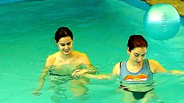 Salacious lesbians fondling in the pool before sharing a double ended dildo