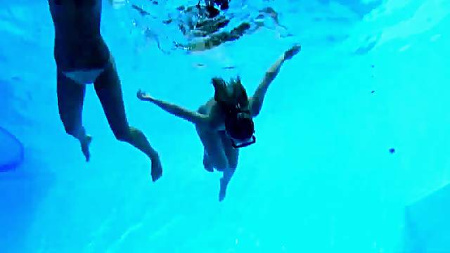 Swimming together in the pool before licking each other's pussies