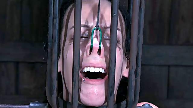 Brunette slave tied facing down when tortured in BDSM