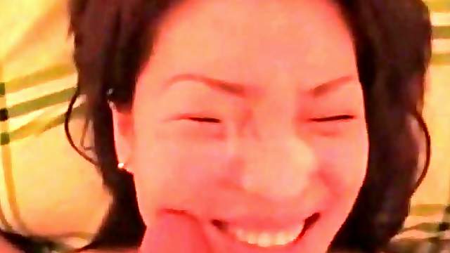 Pretty korean girl is filmed sucking a small cock and taking its cum all over her face.