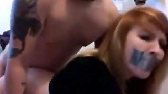Sexy babe with ducttaped mouth fucked