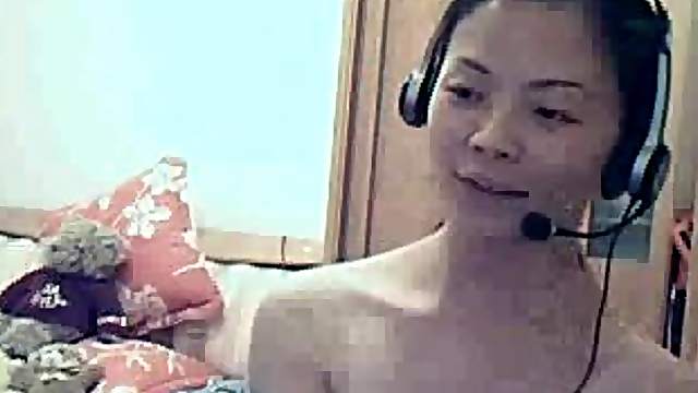Asian babe strips for her BF on the webcam