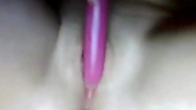 Bored girl plays with a pink dildo