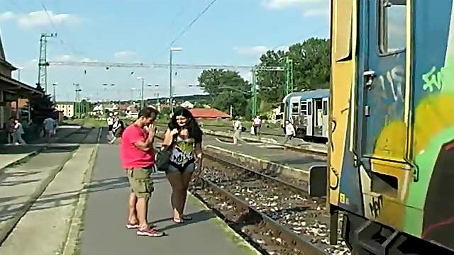 Judy Carmell is outdoors walking along the railroad tracks