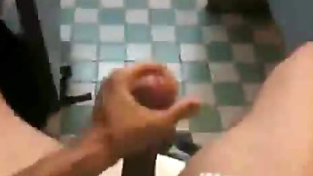 Some fella jerking off in a cubicle