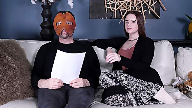 Jessica Kay talks with a masked man backstage at a fetish porn set