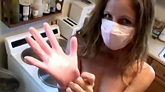 Kinky blonde housewife puts on a mask and gloves and strokes a cock