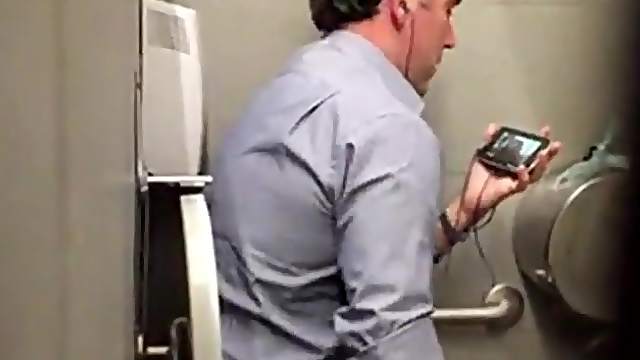 Stranger man in a public toilet filmed on a hidden camera