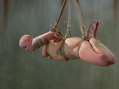 Bald sex slave in tattoos is under pain