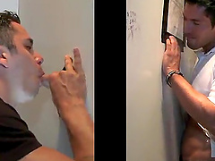 Captivating gay in t-shirt enjoying being given blowjob through gloryhole