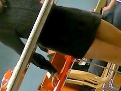 Slim chick wearing a miniskirt gets caught on voyeur's cam at a cafe