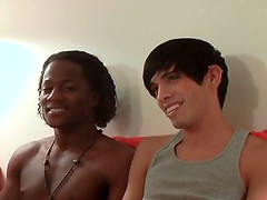 Ebony-skinned gay guy with a slim body sucking a big white cock