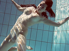 Sexy Sima Lastova reveals her shaved pussy while swimming in the pool