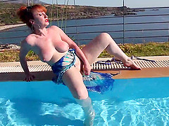 Mature redhead fucking and masturbating poolside