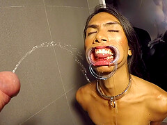 Thai femboy Cat is on the dirty floor of hotel bathroom and looking right on guy's dick in front of her face.