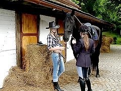 Two beautiful chicks play lesbian games on the stable